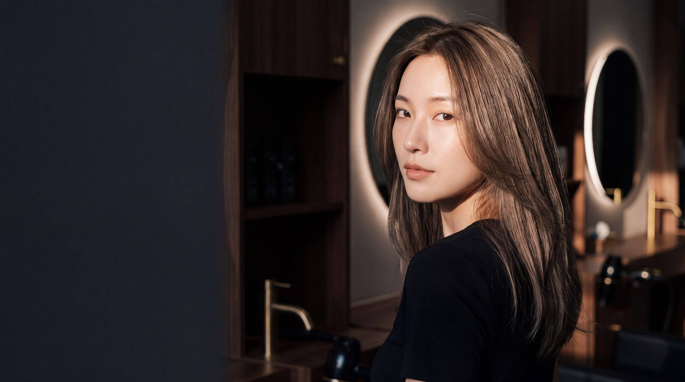 A client at The Gallery Hair Studios with freshly styled ash-brown balayage, photographed in the salon