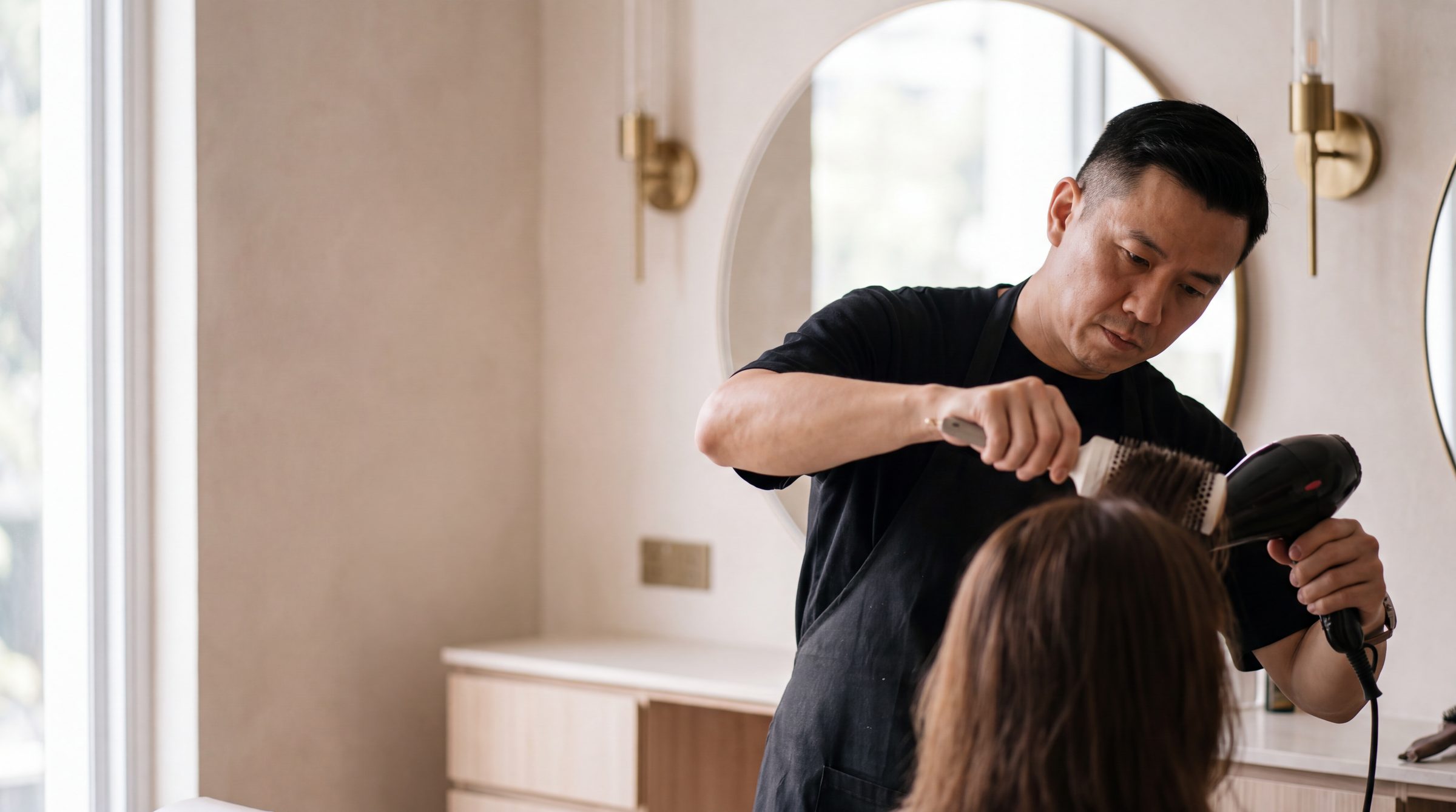 A senior stylist at work at The Gallery Hair Studios